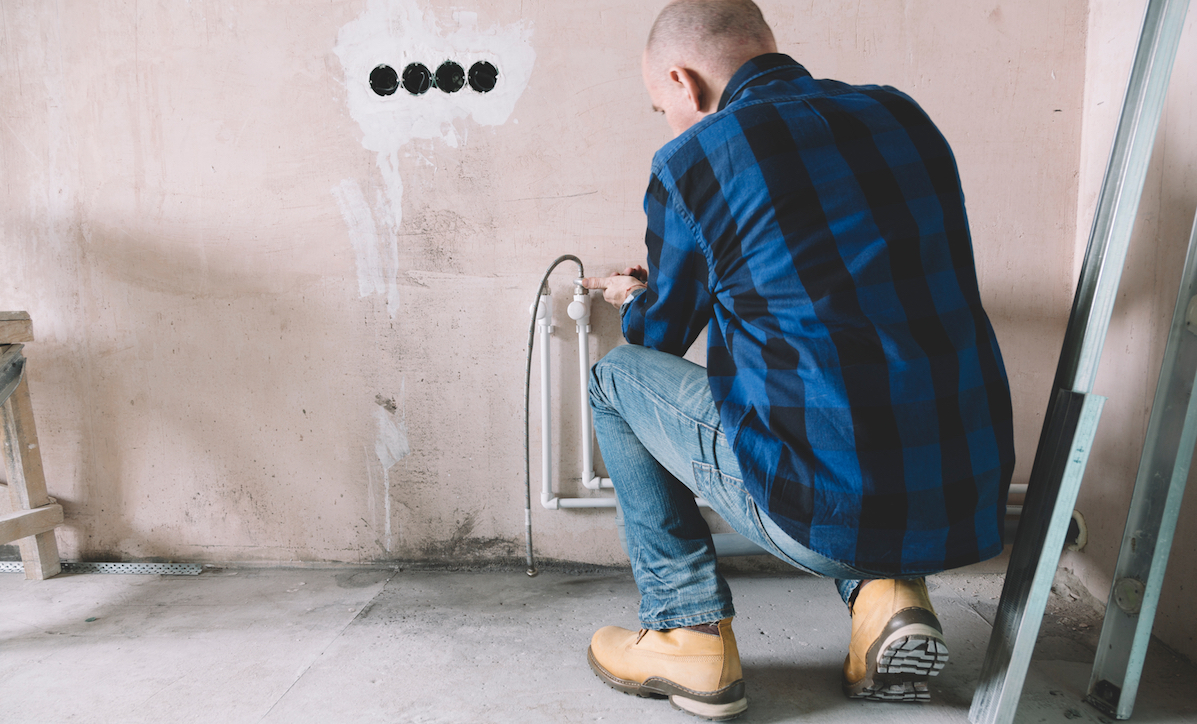 Plumber installing plastic pipes